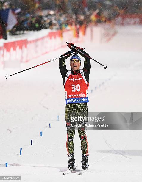 Erik Lesser of Germany celebrates victory as he crosses the finish line in the Men's 15km Biathlon race of the Ruhpolding IBU Biathlon World Cup on...