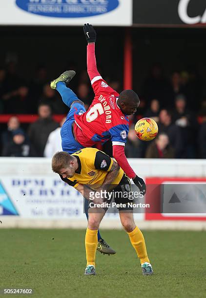 Clevid Dikamona of Dagenham & Redbridge contests the ball with James Collins of Northampton Town during the Sky Bet League Two match between Dagenham...