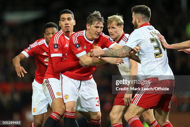 Chris Smalling of Man Utd holds onto teammate Bastian Schweinsteiger during the Emirates FA Cup Third Round match between Manchester United and...
