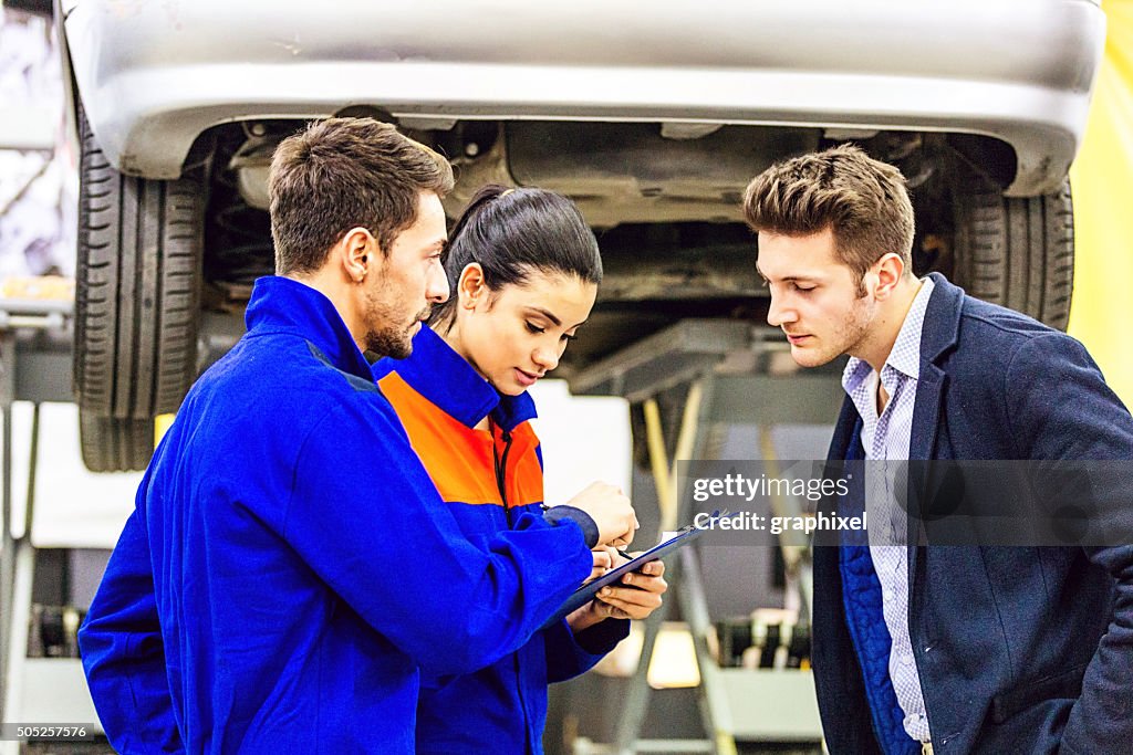 Auto Mechanic Talking With Car Owner