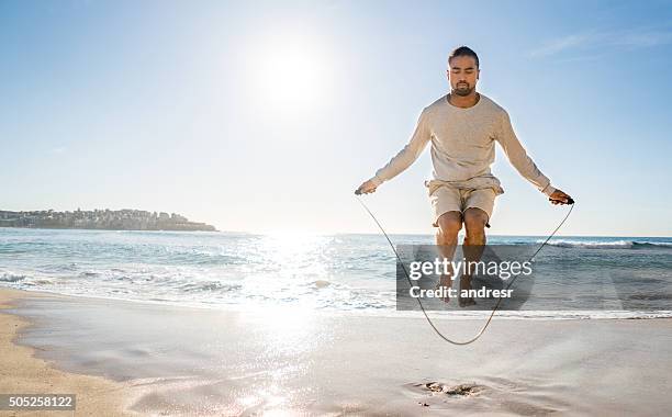 fit man jumping rope at the beach - skipper stock pictures, royalty-free photos & images