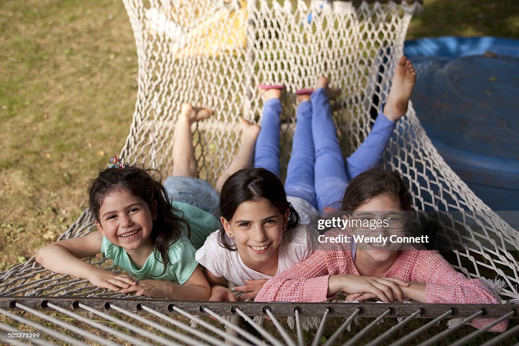 Three sisters lying in hammock