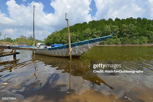 a boat by the bank river, tropical area - kuantan river stock pictures, royalty-free photos & images