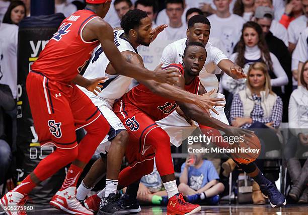 Felix Balamou of the St. John's Red Storm tries to pass off the ball as Tyler Wideman of the Butler Bulldogs defends at Hinkle Fieldhouse on January...