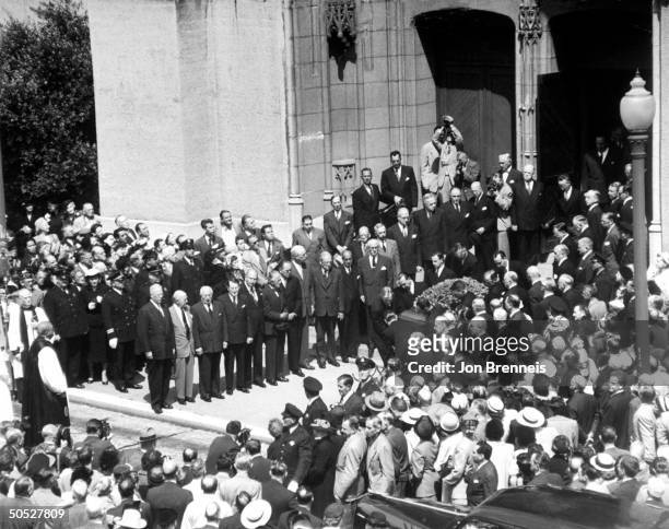 Governor of California Earl Warren standing to the left as an honorary pallbearer at William R. Hearst Sr. Funeral with Hearst Corp. Chairman Martin...
