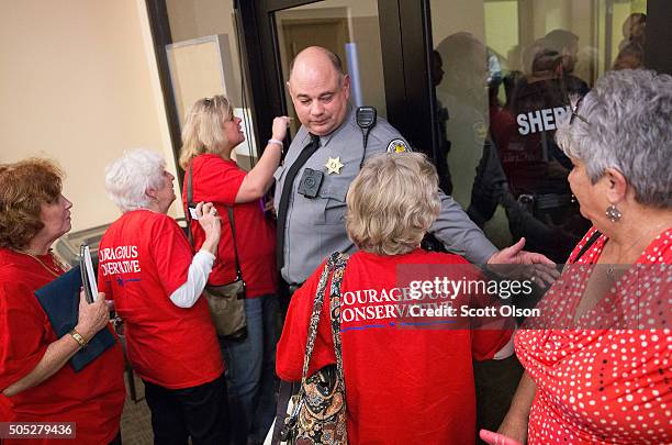 Police officer prevents women from following Republican presidential candidate Sen. Ted Cruz into a secure area after he spoke at the 2016 South...