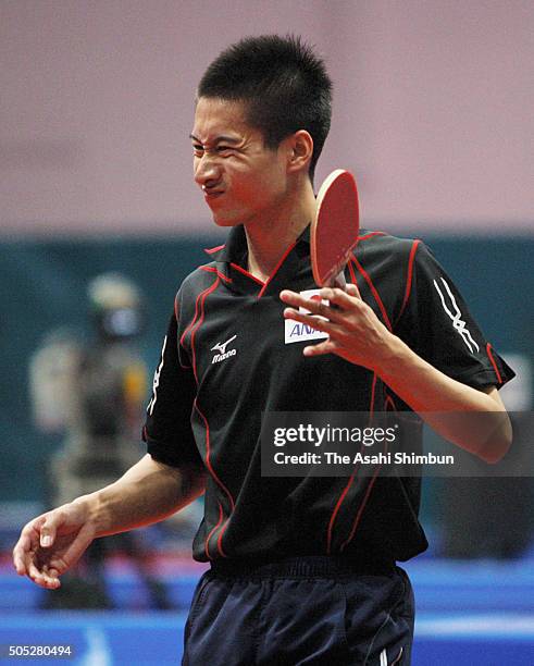 Kaii Yoshida of Japan reacts after losing a point during the Men's team quarter final against Hong Kong at the 15th Asian Games Doha 2006 at Al-Arabi...
