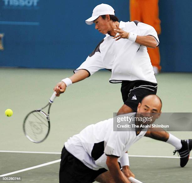 Takao Suzuki and Satoshi Iwabuchi compete in the Tennis Men's Team semi final against Sanchai Ratiwatana and Sonchat Ratiwatana during day five of...