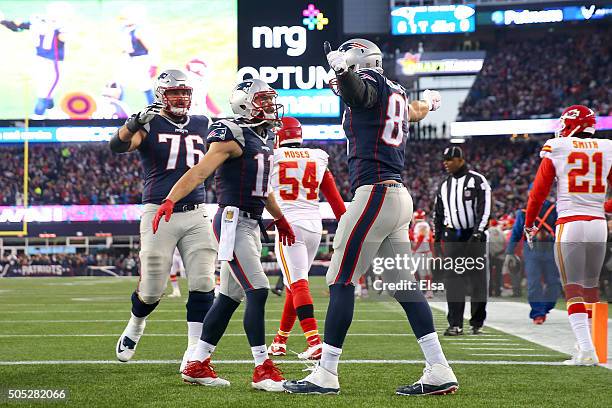 Rob Gronkowski of the New England Patriots celebrates a first quarter touchdown with teammates Julian Edelman and Sebastian Vollmer against the...