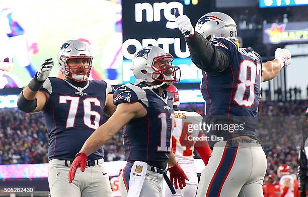 Rob Gronkowski of the New England Patriots celebrates a first quarter touchdown with teammates Julian Edelman and Sebastian Vollmer against the...