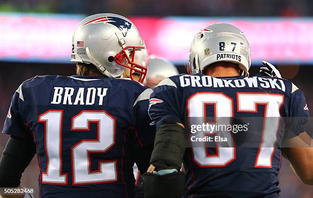 Tom Brady of the New England Patriots speaks to Rob Gronkowski after a first quarter touchdown against the Kansas City Chiefs during the AFC...