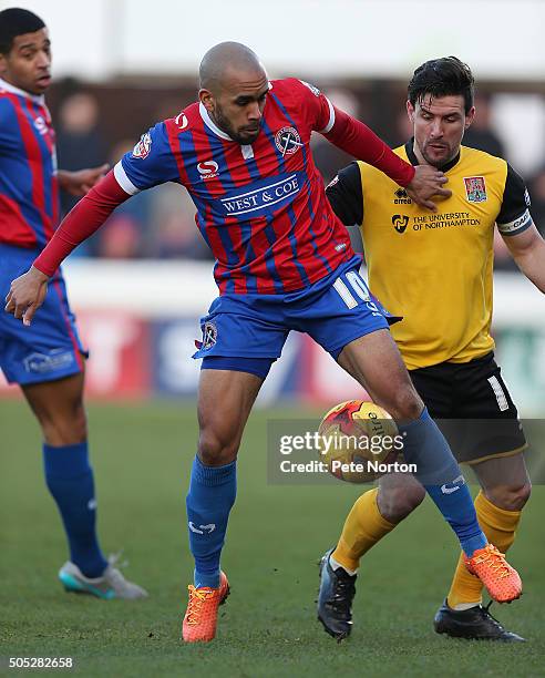 Ashley Chambers of Dagenham & Redbridge holds off the challenge of David Buchanan of Northampton Town during the Sky Bet League Two match between...