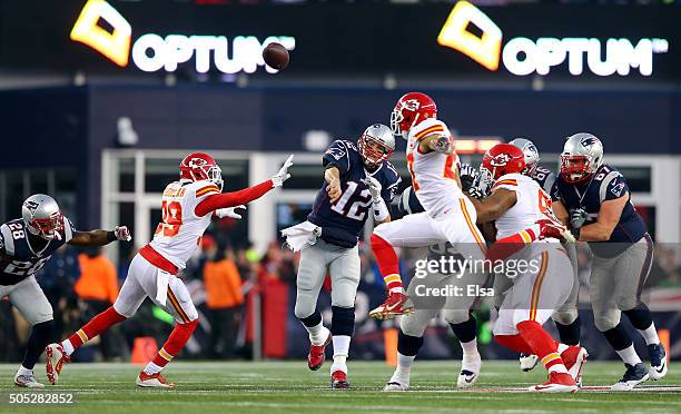 Tom Brady of the New England Patriots passes in the first quarter against Husain Abdullah and Tyvon Branch of the Kansas City Chiefs during the AFC...