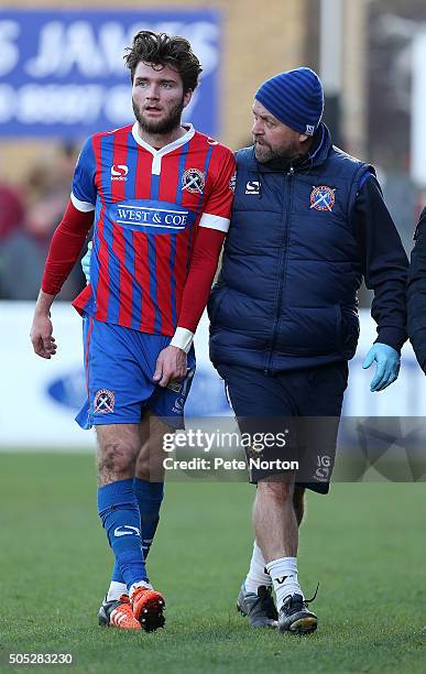 Oliver Muldoon of Dagenham & Redbridge leaves the pitch witth physio John Gowens during the Sky Bet League Two match between Dagenham & Redbridge and...