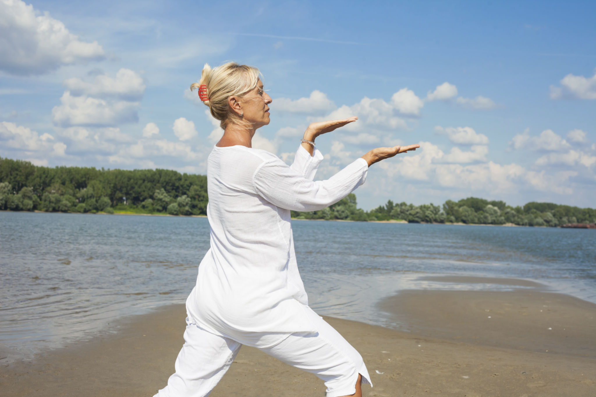 Woman in white clothes doing tai chi Woman in white clothes doing tai chi