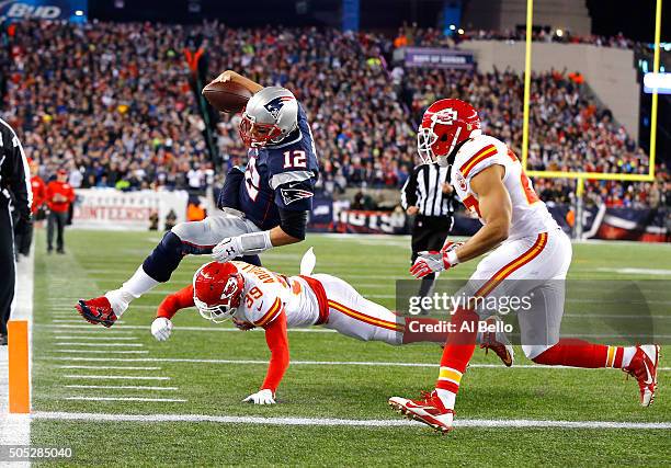 Tom Brady of the New England Patriots dives for the end zone in the second quarter against Husain Abdullah and Tyvon Branch of the Kansas City Chiefs...