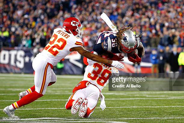 Brandon Bolden of the New England Patriots is tackled by Ron Parker and Marcus Peters of the Kansas City Chiefs in the first half during the AFC...