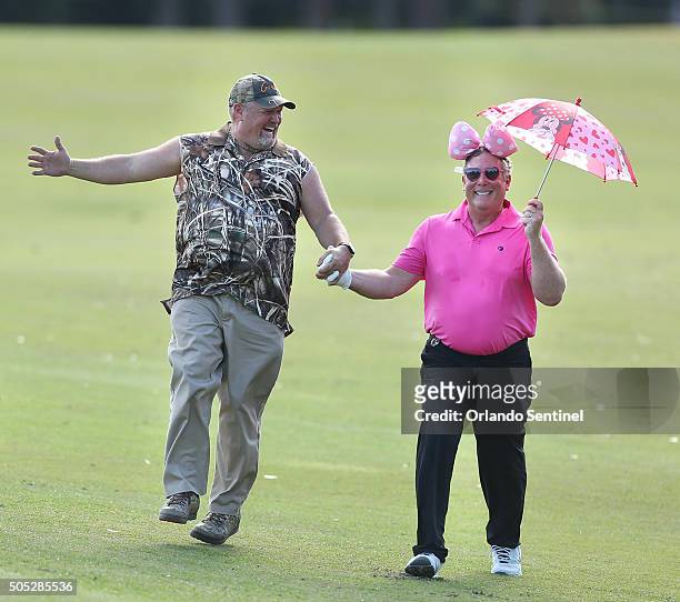 Larry The Cable Guy, left, skips down the 18th fairway with Stephen Cloobeck, right, during the Diamond Resorts Invitational at The Golden Bear Club...