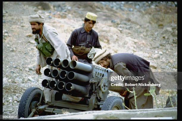 Mujahideen during rebel assault on Jalalabad, loading shells into Chinese BM-12 rocket launcher.