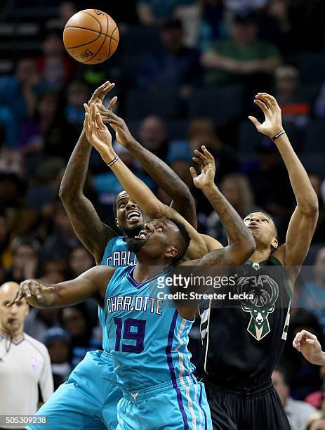 Giannis Antetokounmpo of the Milwaukee Bucks goes after a loose ball against teammates Marvin Williams and P.J. Hairston of the Charlotte Hornets...
