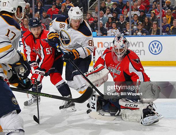 Braden Holtby and Aaron Ness of the Washington Capitals defend against Jamie McGinn of the Buffalo Sabres during an NHL game on January 16, 2016 at...