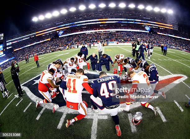 Players from Kansas City Chiefs and New England Patriots gather at mid-field after the AFC Divisional Playoff Game at Gillette Stadium on January 16,...
