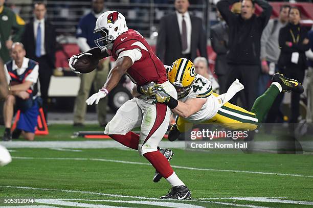 Running back David Johnson of the Arizona Cardinals is hit by inside linebacker Jake Ryan of the Green Bay Packers during the first quarter of the...