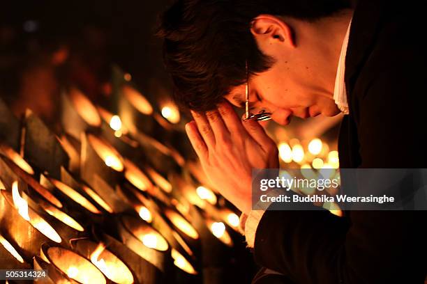 Local resident lights candles and prays for victims of the Great Hanshin earthquake during a memorial ceremony on January 17, 2016 in Kobe, Japan....