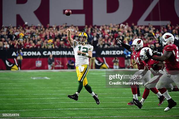 Quarterback Aaron Rodgers of the Green Bay Packers throws a pass during the first half of the NFC Divisional Playoff Game against the Arizona...