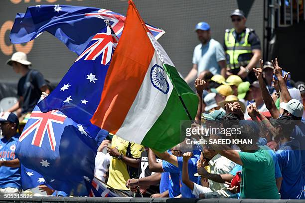 Cricket fans wave national flags of Australia and India prior to the 3rd one-day international at MCG in Melbourne on January 17, 2016. AFP PHOTO /...