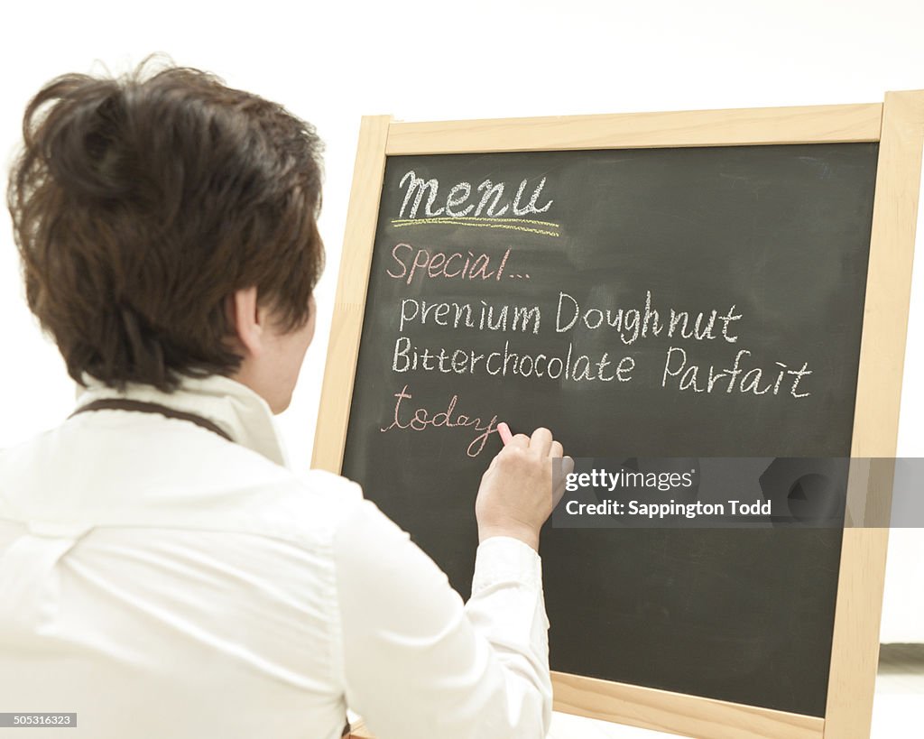 Woman Writing On Chalkboard