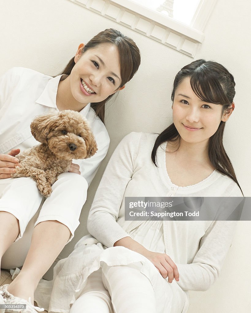 Two Young Women With Toy Poodle