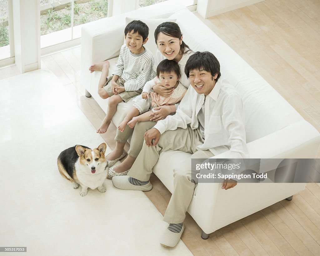 Happy Family With Pet Dog At Home