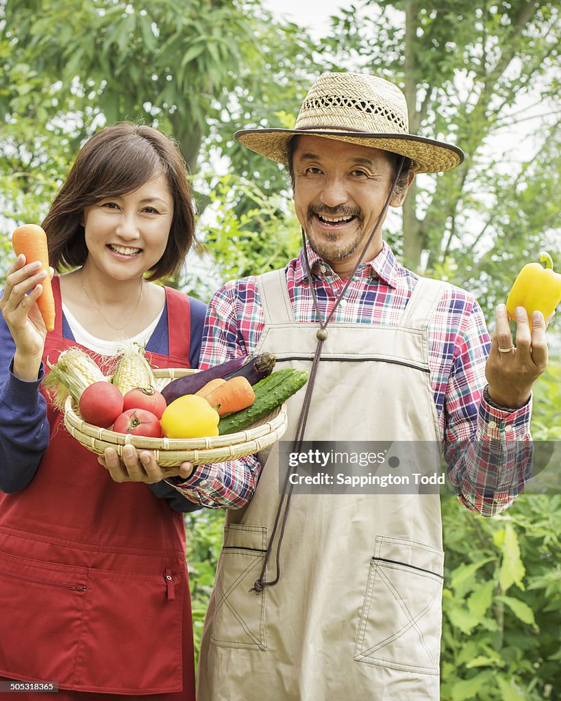 Happy Couple Holding Vegetables