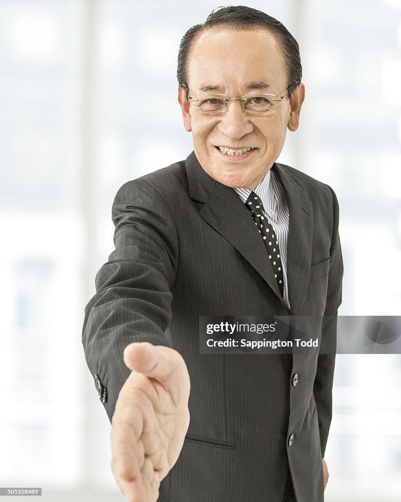 Senior Businessman Offering Handshake