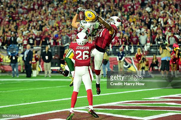 Wide receiver Jeff Janis of the Green Bay Packers catches a 41-yard touchdown on the final play of regulation against cornerback Patrick Peterson of...