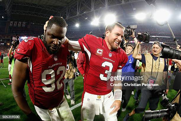 Quarterback Carson Palmer of the Arizona Cardinals celebrates with teammate defensive end Frostee Rucker after beating the Green Bay Packers 26-20 in...