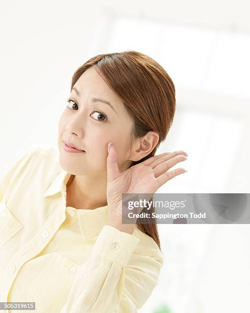 young woman trying to hear - bending stock pictures, royalty-free photos & images