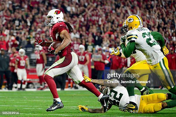 Wide receiver Larry Fitzgerald of the Arizona Cardinals runs past strong safety Morgan Burnett of the Green Bay Packers during overtime of the NFC...