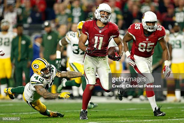 Wide receiver Larry Fitzgerald of the Arizona Cardinals runs past strong safety Morgan Burnett of the Green Bay Packers for a 75-yard run in overtime...