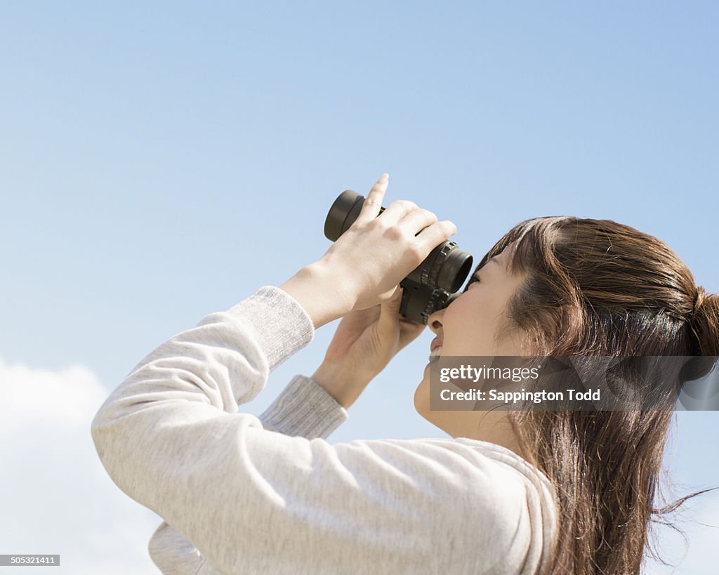 Woman Looking Through Binocular