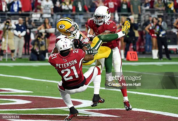 Wide receiver Jeff Janis of the Green Bay Packers hauls in the game-tying pass at the end of regulation while being hit by cornerback Patrick...