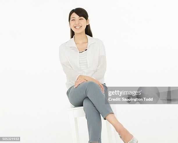 smiling young woman - woman excited sitting chair stock pictures, royalty-free photos & images