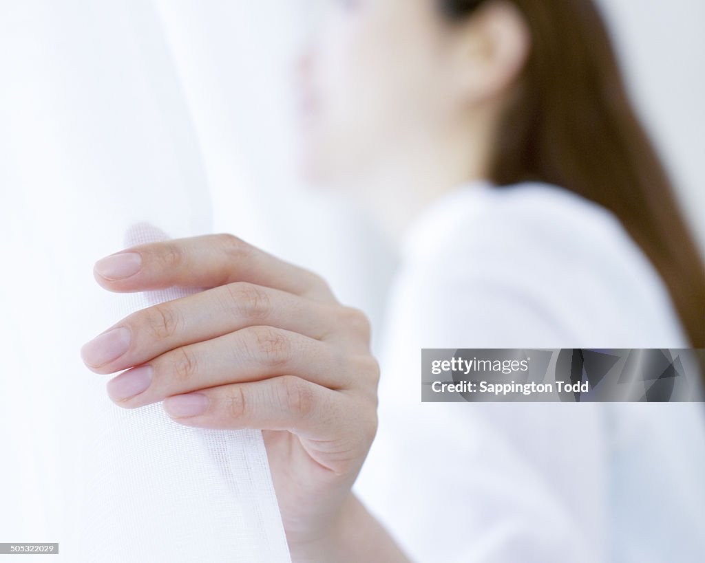 Woman Looking Through Window