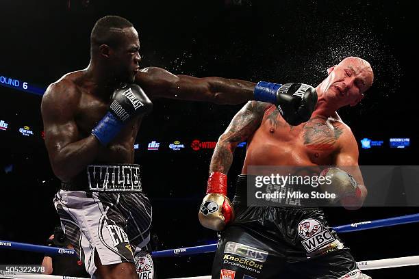 Deontay Wilder punches Artur Szpilka during their WBC Heavyweight Championship bout at Barclays Center on January 16, 2016 in Brooklyn borough of New...