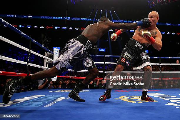 Deontay Wilder punches Artur Szpilka during their WBC Heavyweight Championship bout at Barclays Center on January 16, 2016 in Brooklyn borough of New...