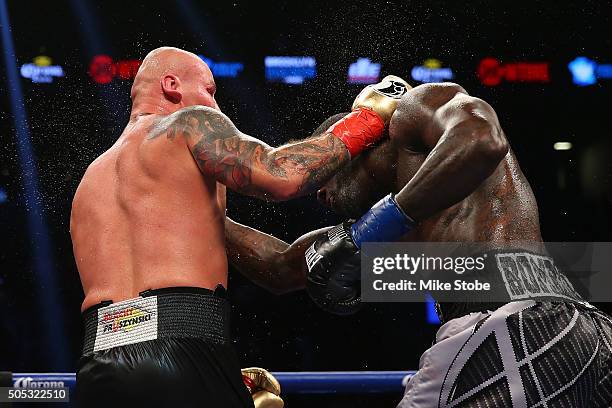 Artur Szpilka punches Deontay Wilder during their WBC Heavyweight Championship bout at Barclays Center on January 16, 2016 in Brooklyn borough of New...