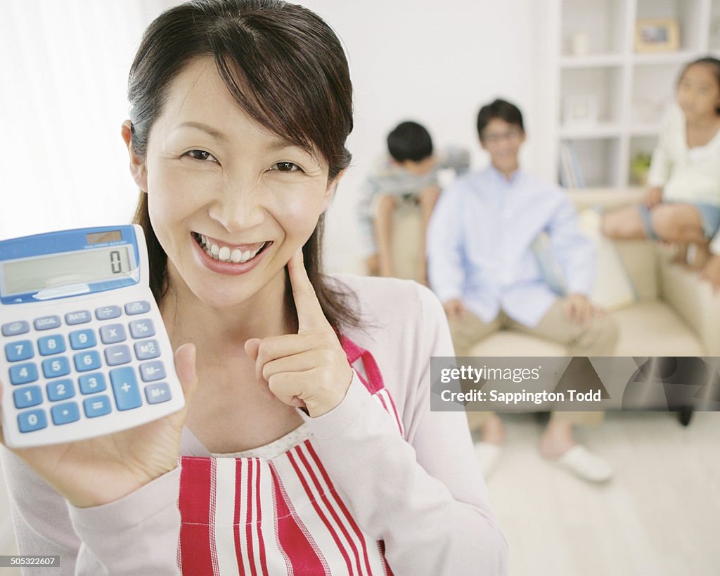 Smiling Woman Showing Calculator