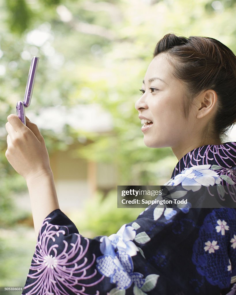 Young Woman In Yukata Using Phone