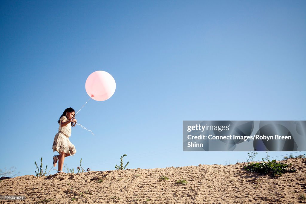 Girl holding large balloon